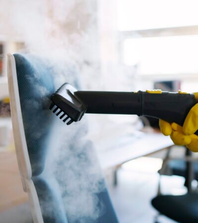 professional-cleaning-service-person-using-steam-cleaner-office